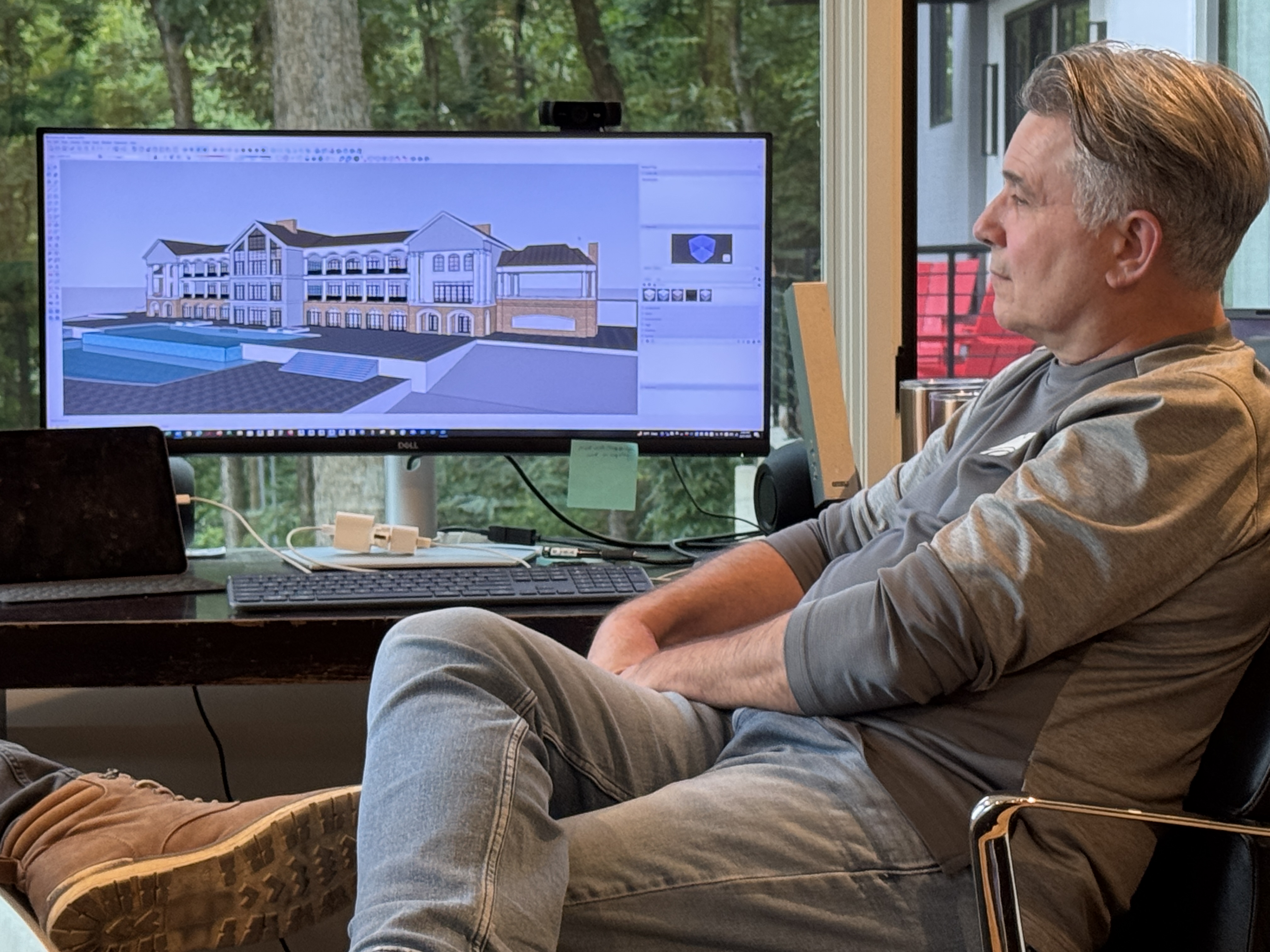Scott reviewing 3D architectural model at his desk