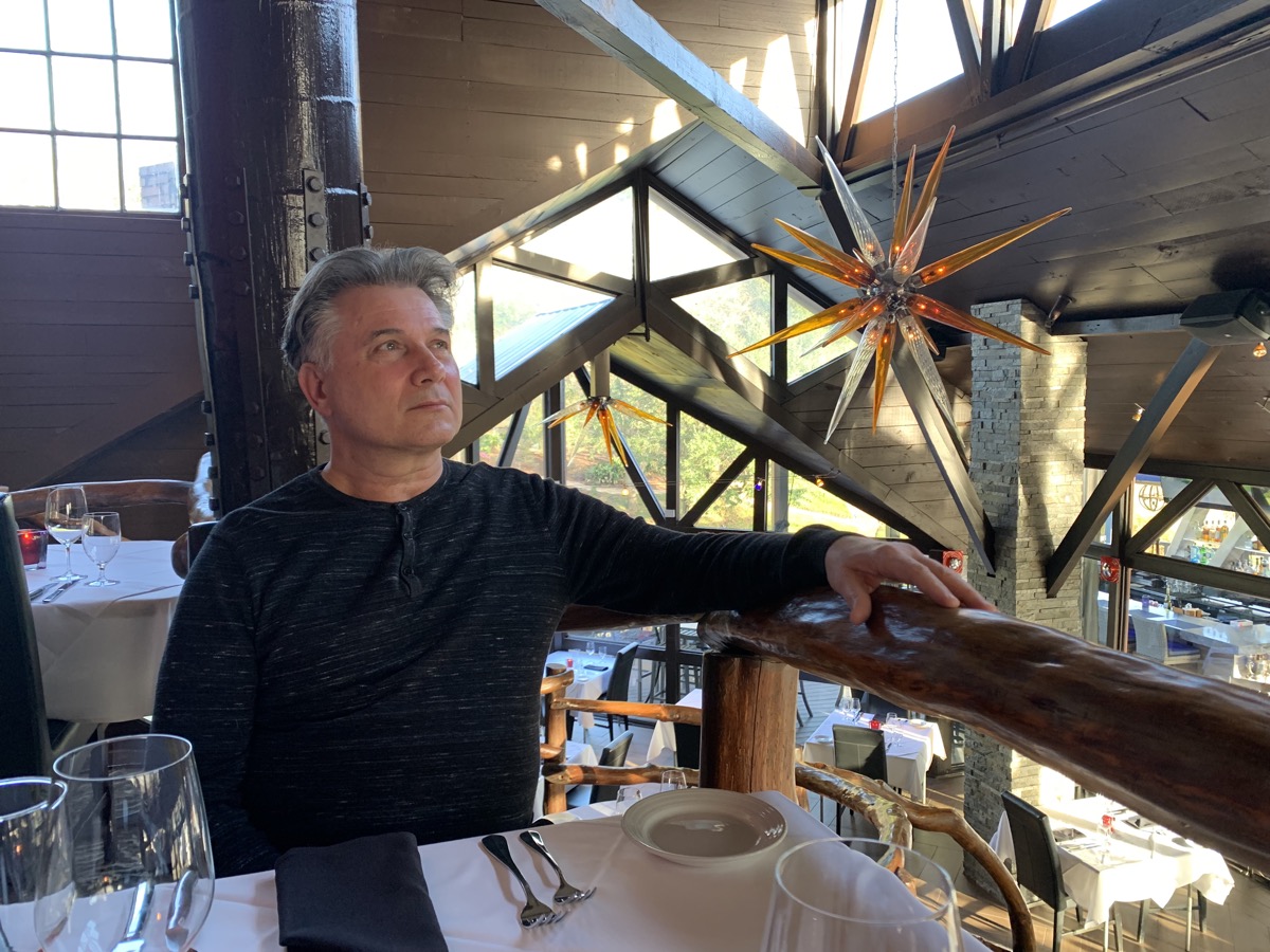 Scott in a timber-and-glass interior — studying light and structure